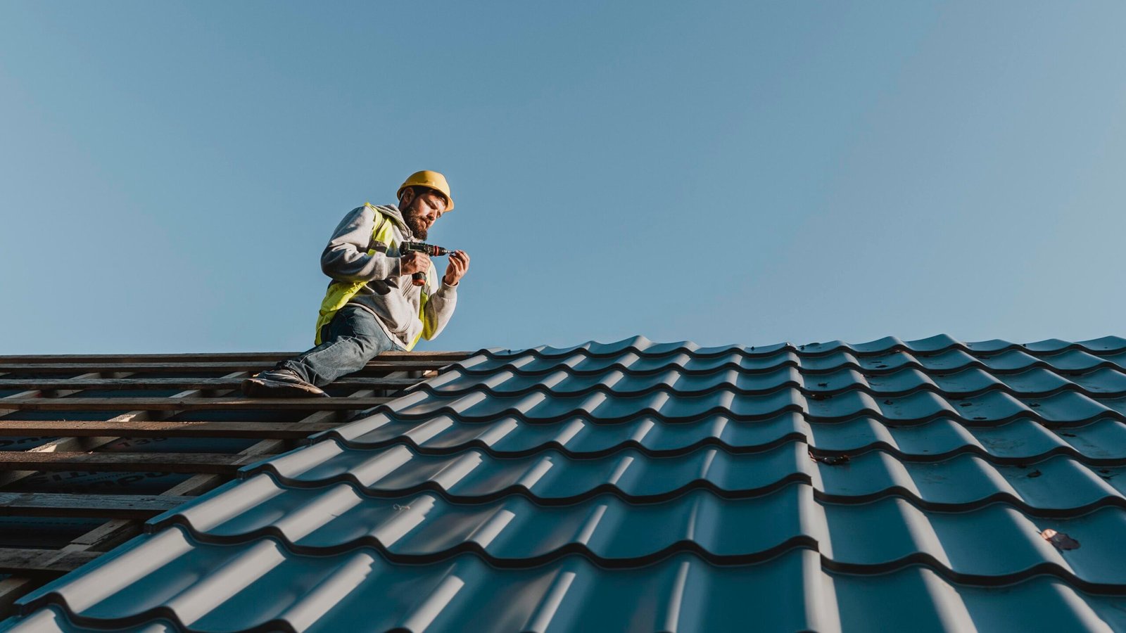 long shot man working roof 2 1 scaled