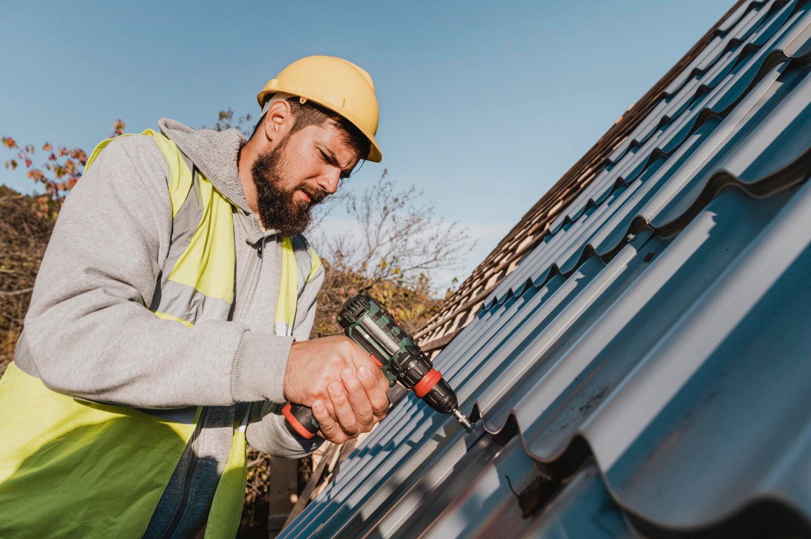 sideways man working roof with drill 1 scaled